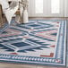 An Abani Molana Collection beige and blue southwestern diamond area rug on the floor.