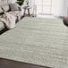 A cream and gray striped Abani Cabo Collection area rug in a room.