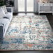 An Abani Casa Collection gray and blue abstract area rug with orange tones in a room.