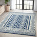 An Abani Casa Collection navy and cream area rug with a Southwestern geometric design.