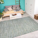 A room with a Couristan Cape Falmouth Ivory / Hunter Runner Rug and a white bed.
