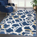 An Abani Atlas Collection blue and gray hexagon area rug with geometric patterns on a floor in a lounge area.