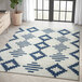 An Abani Casa Collection navy and cream area rug with geometric designs.