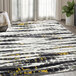 A yellow and gray contemporary area rug with a distressed striped design.