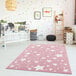 A white baby's room with a pink Abani Play Collection rug with stars.