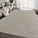 A beige and brown Abani Layla Collection area rug with a distressed pattern in a room.