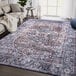 A dark blue and terracotta vintage medallion area rug in a room.