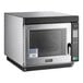 An Amana stainless steel commercial microwave with a black handle and window.