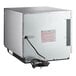 An Amana stainless steel commercial microwave oven with a black power cord.