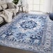 An Abani Molana Collection beige and blue area rug with a vintage traditional medallion design in a living room.