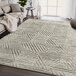 An Abani Cabo Collection cream and gray geometric triangle area rug on a floor.