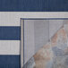 A Couristan Afuera Yacht Club area rug with blue and white stripes.