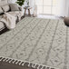 An Abani Layla Collection beige and brown area rug with a diamond pattern and fringes.