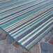 A close-up of a blue and teal striped Couristan Cape Brockton area rug.