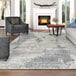 A Couristan ivory and gray runner rug in a living room with grey and white furniture.