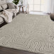 A beige and brown geometric area rug from the Abani Layla Collection on a floor.