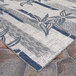A close-up of a Couristan Ivory and Cape Blue Bamboo Stripe area rug.