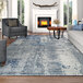 A living room with a Couristan Dreamscape Odyssey gray and blue runner rug under a wood table and a couch.