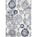 A close-up of a cream rug with a blue and white distressed medallion pattern.