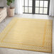 A yellow Abani Casa Collection Moroccan area rug with geometric designs in a room.