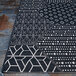 A black and white Couristan Afuera Anode runner rug with geometric patterns.