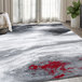 A gray and red Abani Arto Collection area rug with a contemporary design in a room.