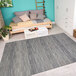 A white bedroom with a Couristan Cape Fayston silver and charcoal area rug under a bed.