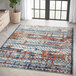 An Abani Casa Collection 6' x 9' multicolor area rug with a distressed contemporary pattern in a room.