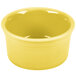 A yellow Fiesta ramekin with a white edge on a white surface.