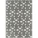 A cream and grey rectangular area rug with geometric patterns including triangles.
