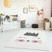 A white baby's room with an Abani pink and cream kitten rug.