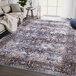 An Abani Lola Collection brown and blue vintage floral medallion area rug.