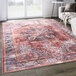 An Abani Lola Collection terracotta area rug with a vintage medallion design on a floor.