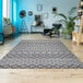 A Couristan Hadron area rug with a modern geometric pattern in a room.