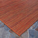 A close up of a Couristan Cape Hinsdale runner rug with orange stripes.