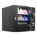 A black Seaga countertop snack vending machine with snacks behind a glass door.