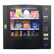 A Seaga countertop vending machine filled with snacks and chips.