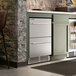 A stainless steel single temperature beverage cooler with two drawers built into a kitchen counter.