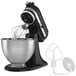 A black KitchenAid stand mixer with a bowl and a whisk attachment.