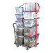 A Snap-Loc push cart with plastic bins strapped to it.