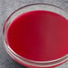 A glass bowl of Les Vergers Boiron Prickly Pear fruit puree on a table.