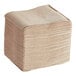 A large stack of natural kraft Tork interfold dispenser napkins.