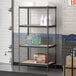 A Lavex black metal boltless shelving unit with containers and boxes on the shelves.