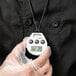 A hand holding a Taylor digital kitchen timer.