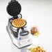 A Waring Double Belgian Waffle Maker with waffles on a plate and syrup.