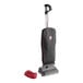 A Hoover Superior Lite upright vacuum cleaner with a red cord and black bag with red trim.