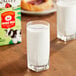 A glass of Organic Valley whole milk on a table.