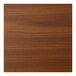 A close-up of a light walnut woodgrain table top.