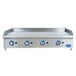 A Globe stainless steel countertop gas griddle with blue knobs on a large rectangular metal surface.