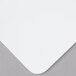 A white Tablecraft flexible cutting board on a gray surface.